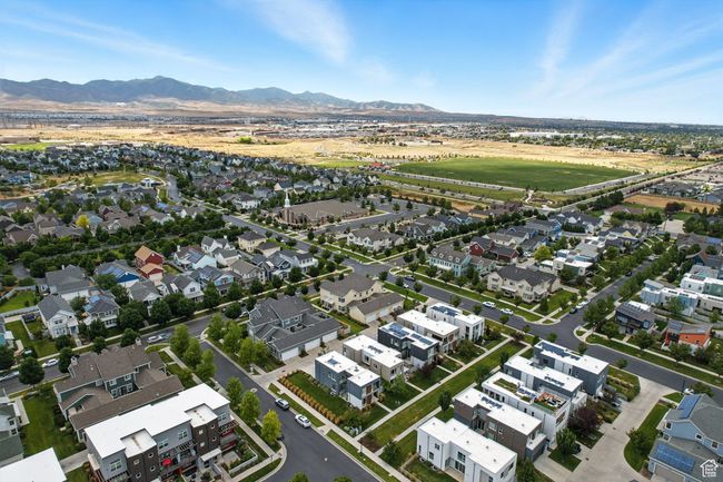 Aerial overview of property's location with nearby suburban area and a mountain backdrop | Image 62