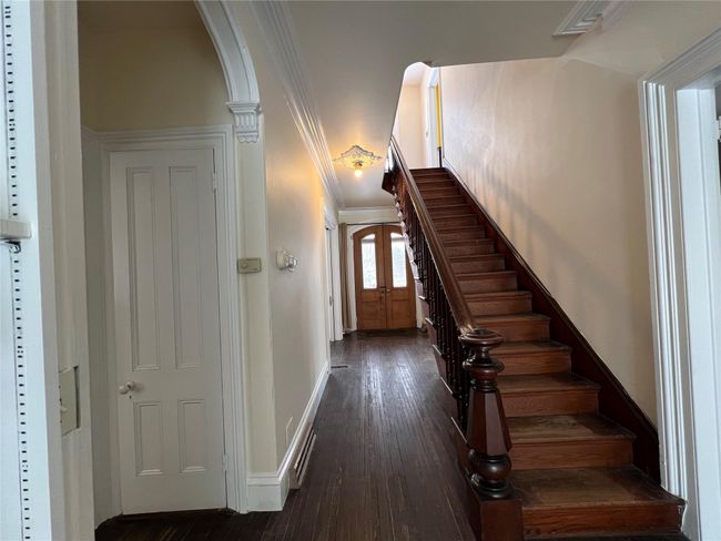 Stairway featuring arched walkways, baseboards, and wood finished floors | Image 17