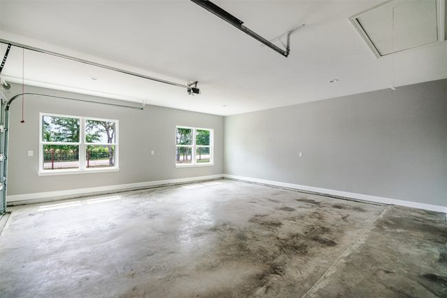 Garage with baseboards and a garage door opener | Image 27