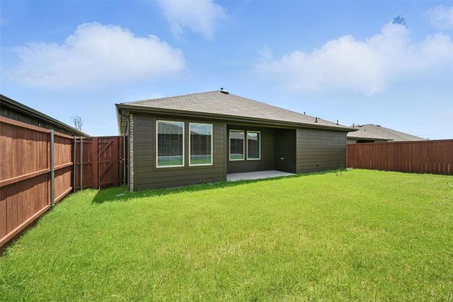Rear view of house with a fenced backyard, a patio, and roof with shingles | Image 21