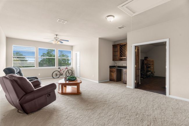 Upstairs gameroom and three storage closets and an attic access. | Image 30