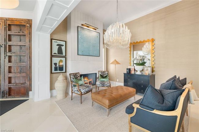 Sitting room featuring baseboards, an inviting chandelier, and tile patterned flooring | Image 19