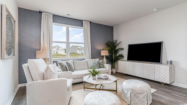 Living room featuring wood finished floors and baseboards | Image 4