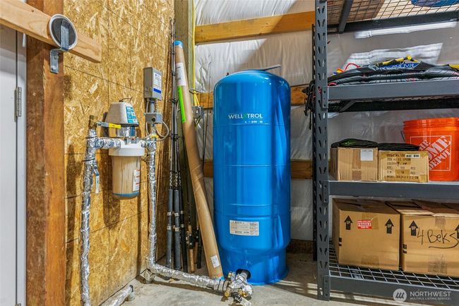Well equipment is in the garage. The well is 183' deep and is located outside of the garage. | Image 22