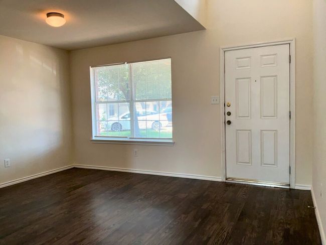 Foyer entrance featuring baseboards and dark wood-type flooring | Image 7