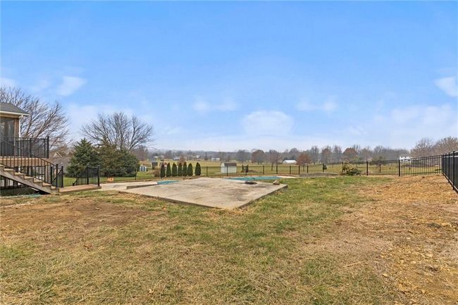 View of yard with a rural view, a patio area, and a covered pool | Image 36