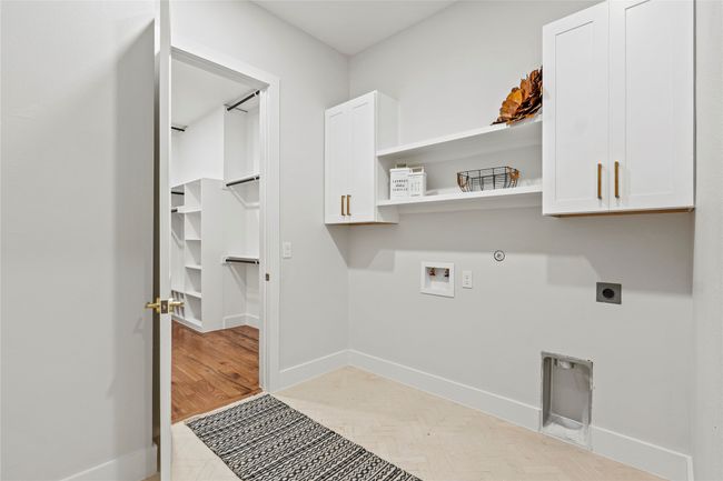 Laundry area featuring cabinet space, hookup for an electric dryer, washer hookup, and gas dryer hookup | Image 25