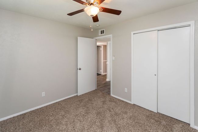 Empty room featuring ceiling fan and carpet | Image 27