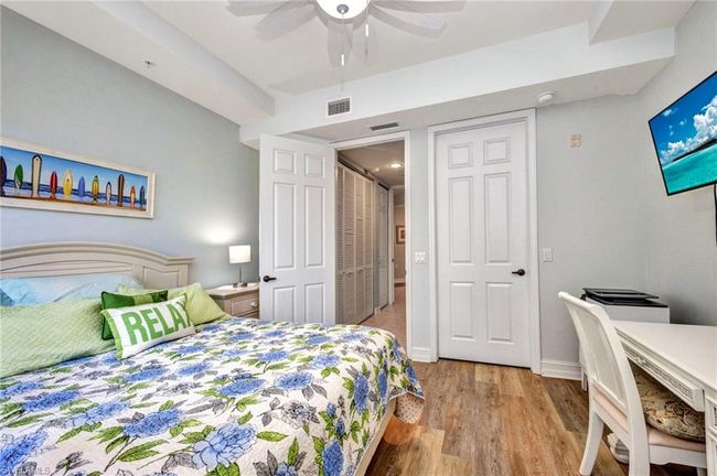 Bedroom with wood finished floors and ceiling fan | Image 26
