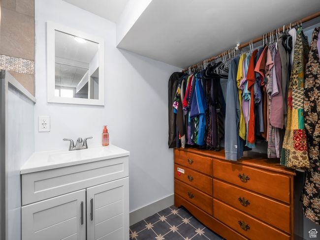 Spacious closet featuring a sink and dark flooring | Image 22