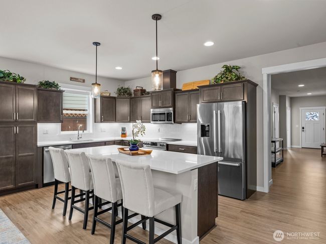 Gorgeous cabinets and stunning countertops elevate the space. | Image 10