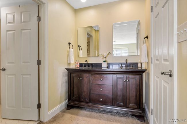 Full bathroom featuring double vanity, a sink, and baseboards | Image 24