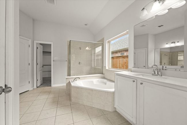 The primary bathroom features a garden tub and separate shower. | Image 16