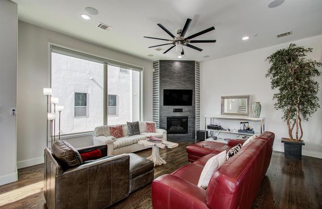 A cozy fireplace is the center of this large living space on the 2nd floor. | Image 7