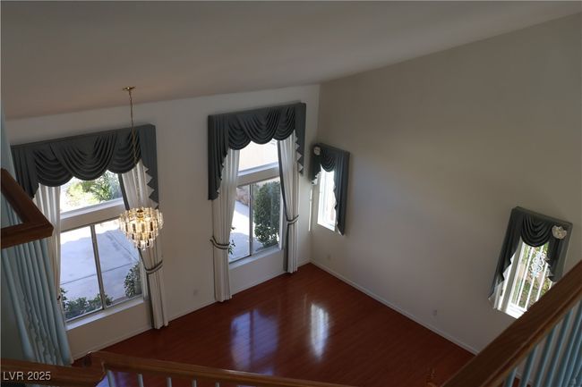 Foyer entrance featuring wood finished floors, a chandelier, and plenty of natural light | Image 38