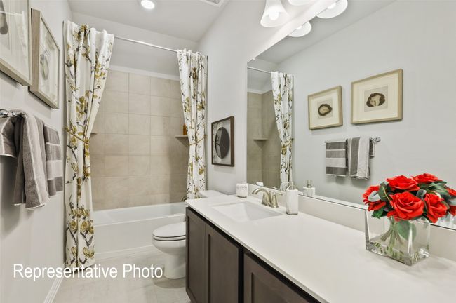 Full bathroom with shower / bath combo, toilet, vanity, and tile patterned flooring | Image 16