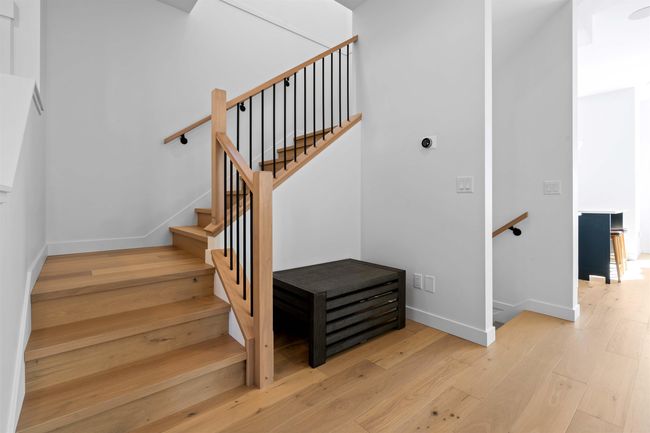 Stairs featuring baseboards and wood-type flooring | Image 16