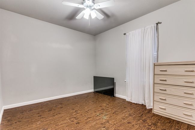 Spare room featuring ceiling fan and dark hardwood / wood-style floors | Image 13