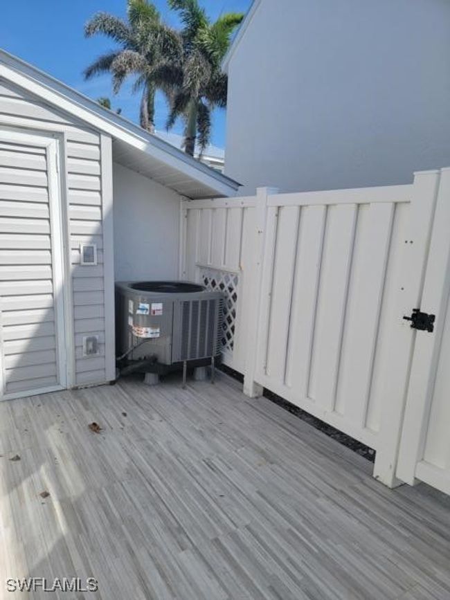 Front terrace featuring central AC unit and storage shed | Image 24