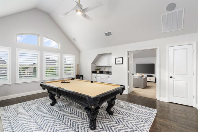 Plantation shutters and open to the theater room make this space available as a game room, secondary living room, play area or whatever your family needs desire. | Image 26
