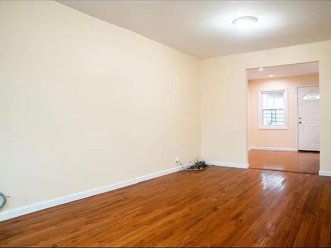 Spare room with wood finished floors and baseboards | Image 12