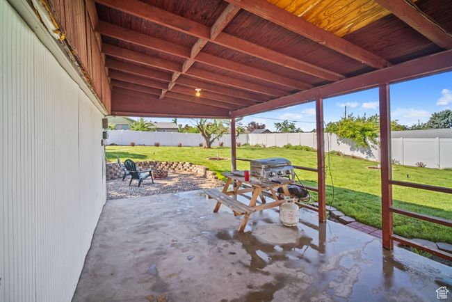 View of patio featuring a fire pit and grilling area | Image 31