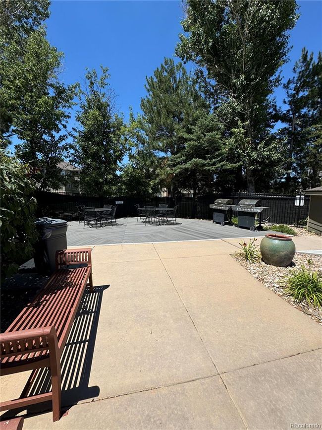 Clubhouse patio with BBQ grills and tables for your outdoor parties at the pool and hot tub. Call the neighbors...it's time to grill and chill! | Image 28