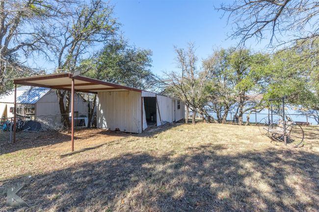 View of yard with an outbuilding, fence, and a carport | Image 10