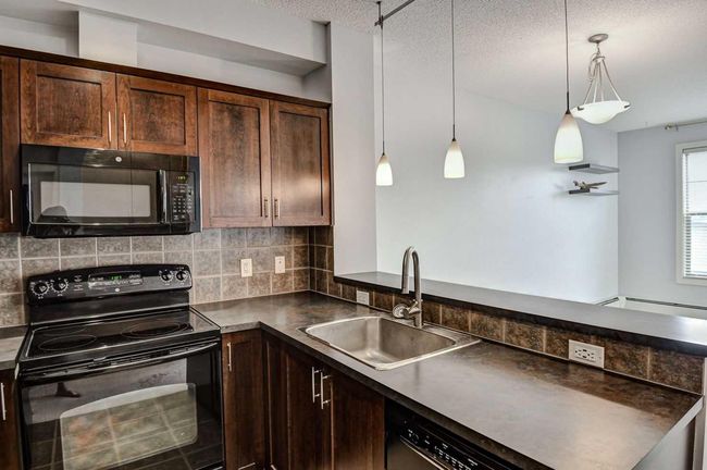 412 - 201 Sunset Dr, Condo with 1 bedrooms, 1 bathrooms and 2 parking in Cochrane AB | Image 4