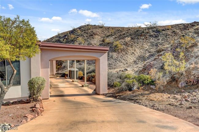 View of exterior entry featuring a mountain view, stucco siding, and driveway | Image 57