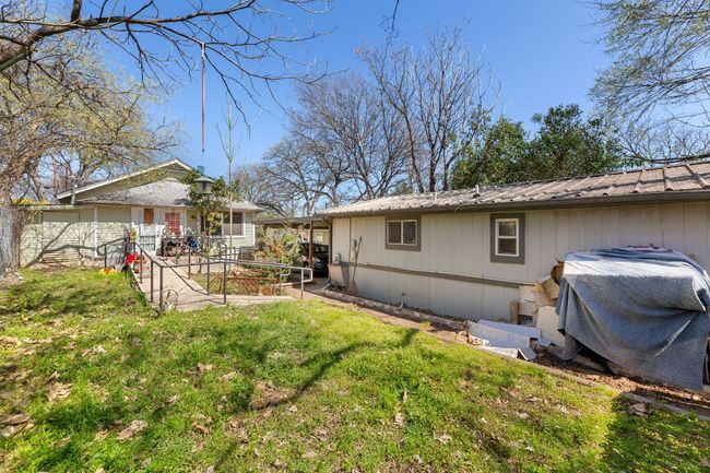 Rear view of house with a yard, metal roof, and fence | Image 23