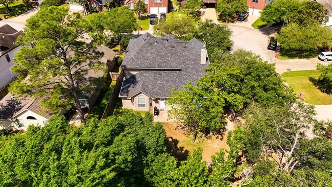 This aerial shot captures the full scope of the backyard, highlighting the ample space for outdoor activities, while offering a clear view of the home’s position on the corner lot within the community. It’s the perfect spot to relax or entertain, with plenty of room for a pool, garden, or play area. | Image 36