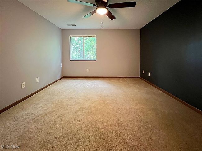 Second bedroom with light carpet and a ceiling fan | Image 14