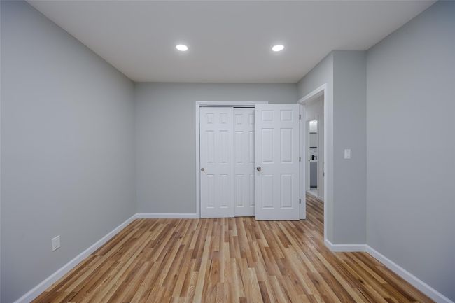 Unfurnished bedroom featuring light wood-type flooring and a closet | Image 27