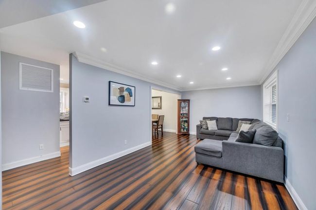 Living room with ornamental molding and baseboards | Image 10