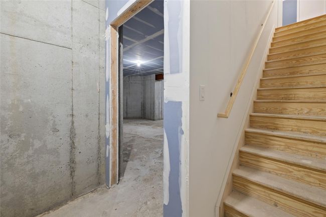Stairs featuring unfinished concrete floors | Image 34