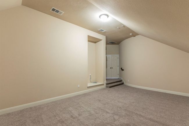 Media room featuring vaulted ceiling, visible vents, and carpet floors | Image 24