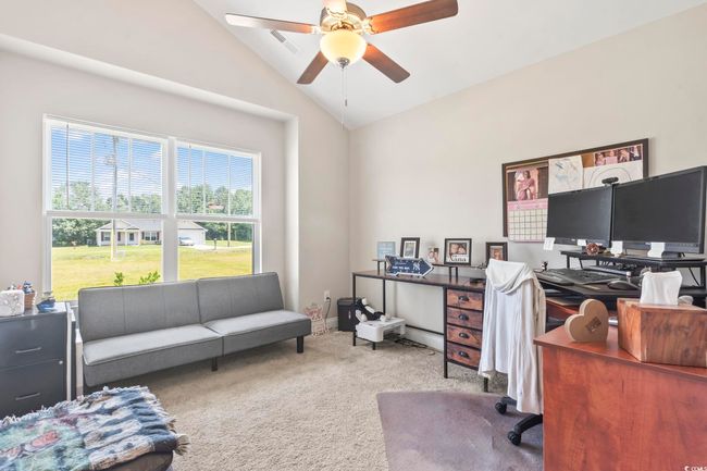 Carpeted office space with vaulted ceiling and ceiling fan | Image 17