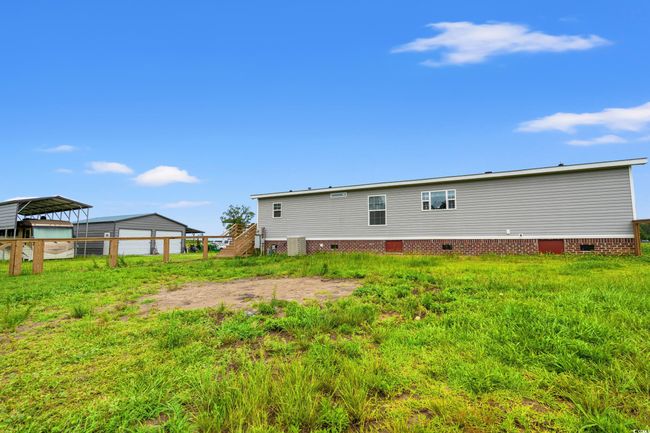 Rear view of property featuring crawl space and a detached carport | Image 27