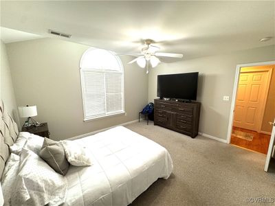 Bedroom with ceiling fan and light carpet | Image 3