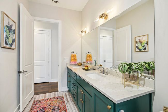Bathroom featuring double vanity and wood finished floors | Image 27