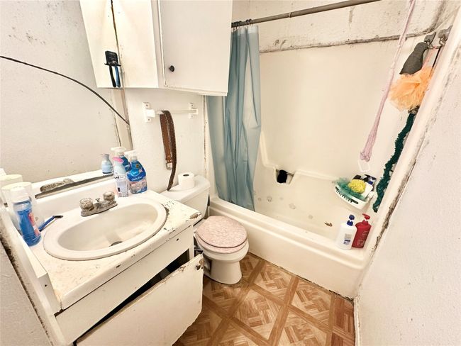 Bathroom with vanity, shower / bathtub combination with curtain, and toilet | Image 14