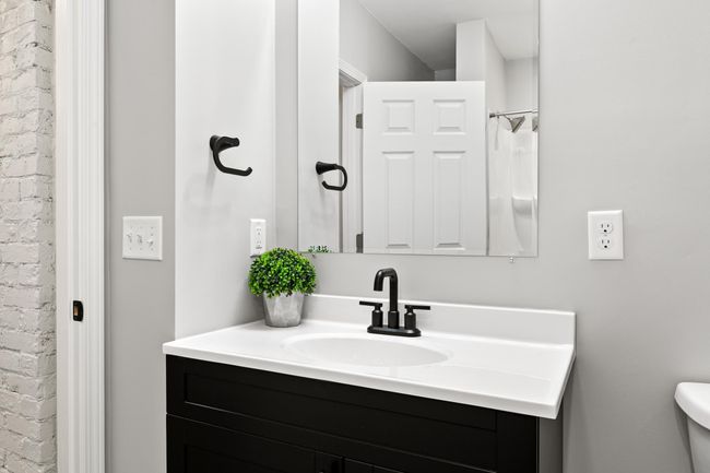 The bathroom is spacious and includes a new vanity and fixtures. | Image 17