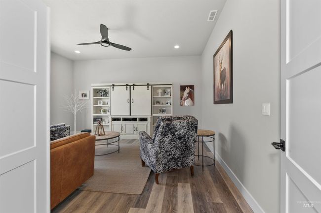 Sitting room with wood finished floors, ceiling fan, and recessed lighting | Image 7
