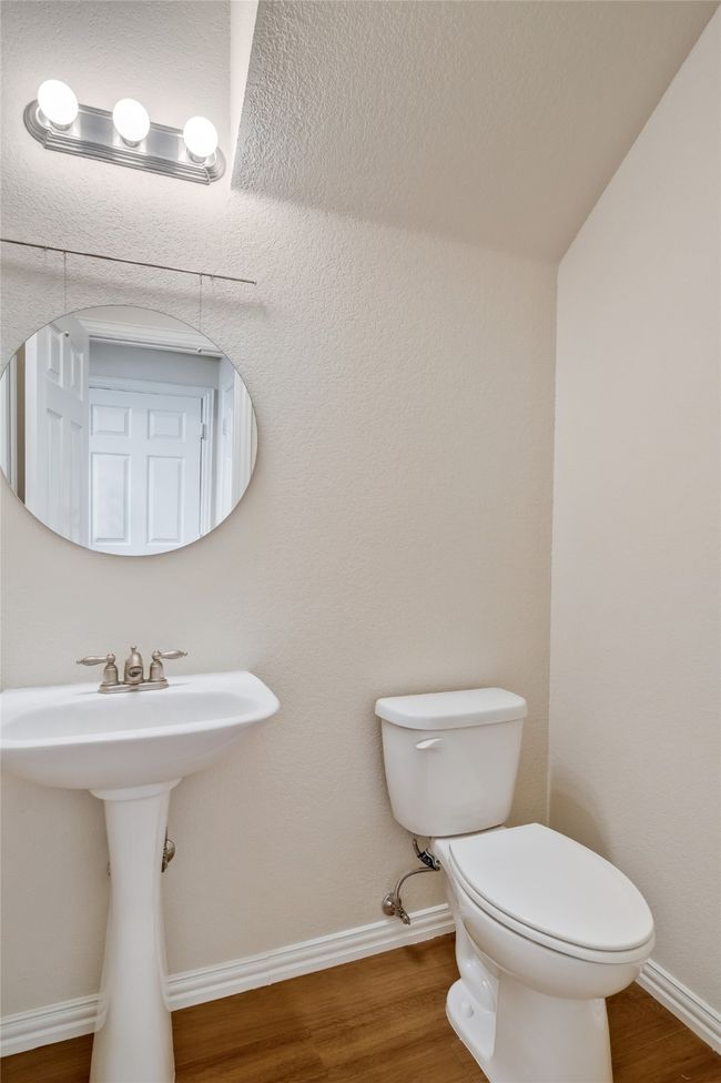 Bathroom featuring toilet, wood finished floors, and baseboards | Image 13