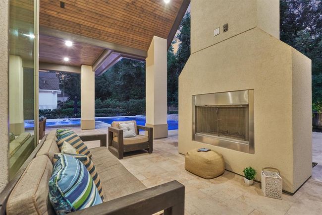 Outdoor living area with fireplace. | Image 47