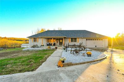 Ranch-style house with a garage and a front yard | Image 1