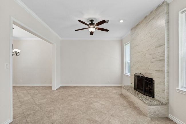 Unfurnished living room featuring a high end fireplace, a ceiling fan, and crown​​‌​​​​‌​​‌‌​‌‌​​​‌‌​​‌‌​‌​​​​​‌ molding | Image 6
