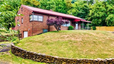 View of front of house featuring a garage and a front yard | Image 1