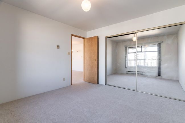 Unfurnished bedroom featuring carpet flooring, baseboard heating, and a closet | Image 9